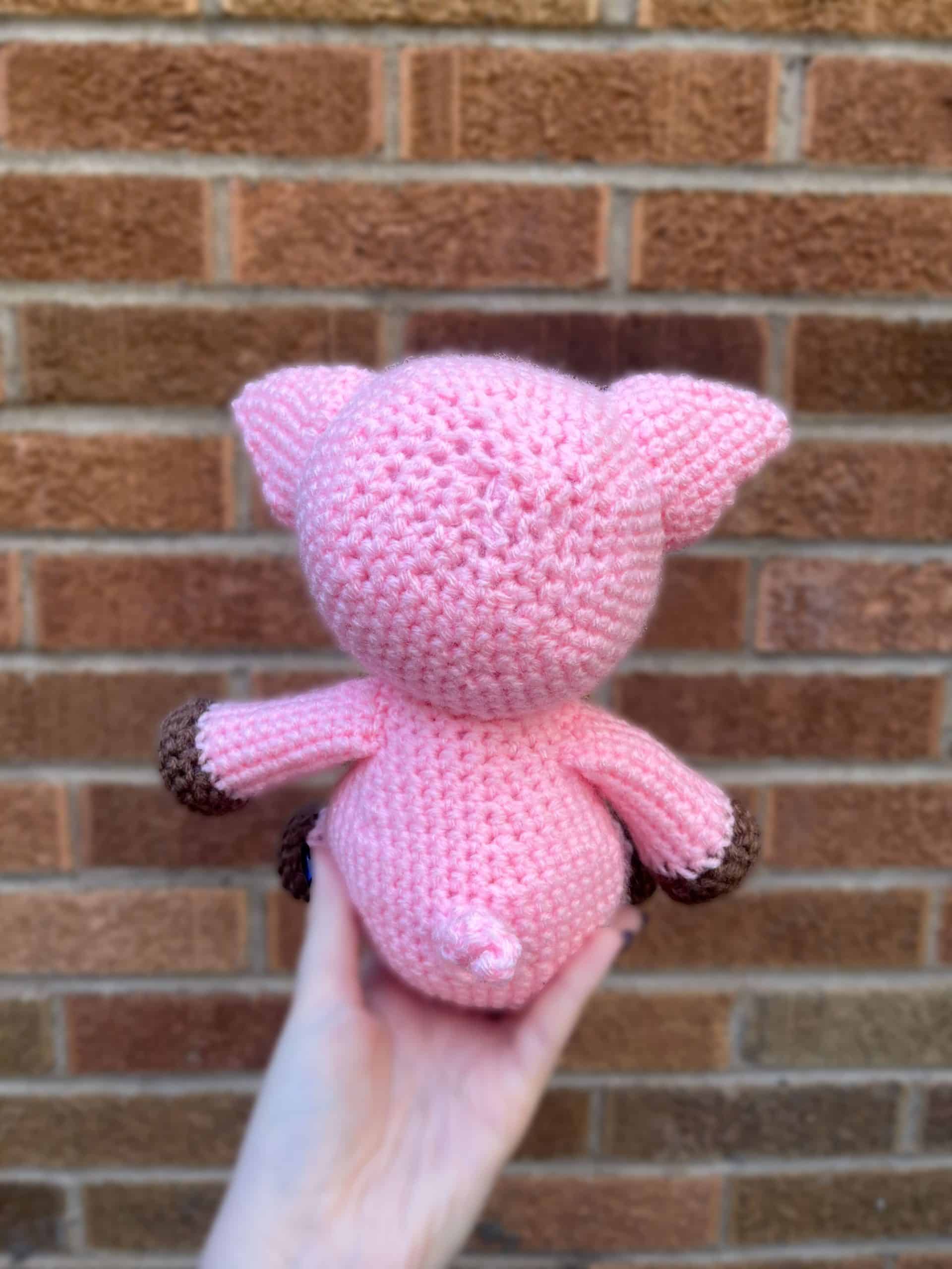 Pink Pig in front of a brick wall back